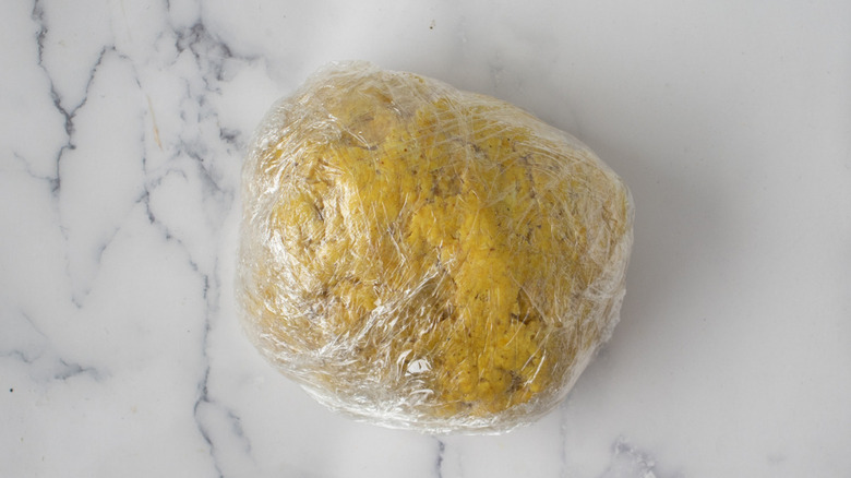 dough covered in plastic wrap