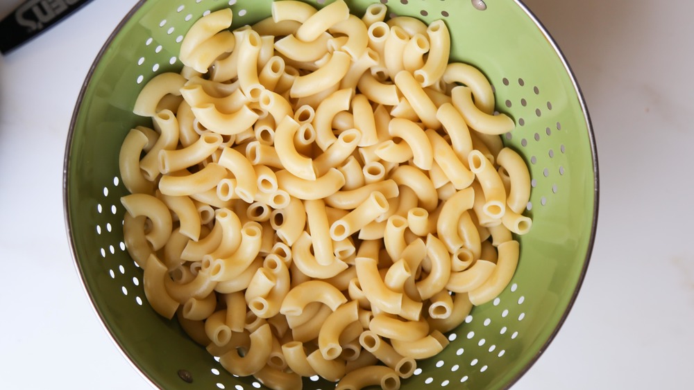 cooked macaroni in strainer for baked mac and cheese