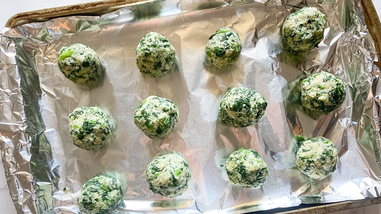 parmesan spinach balls on baking sheet