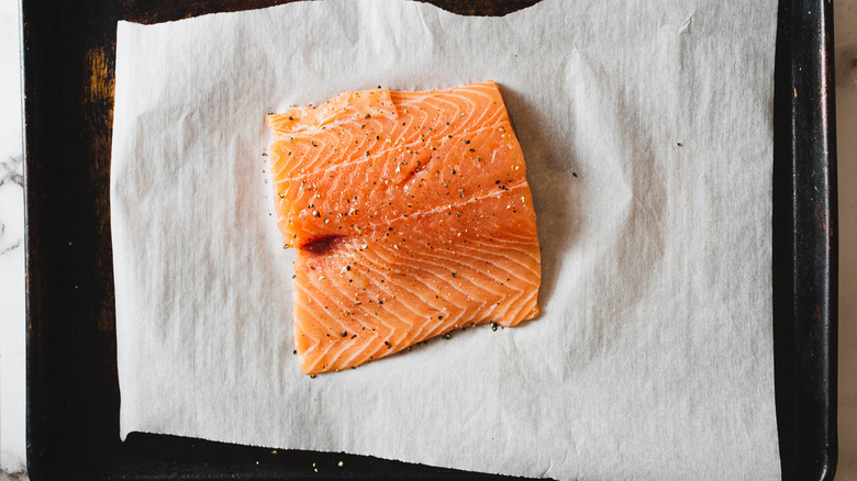 raw salmon slab on baking sheet