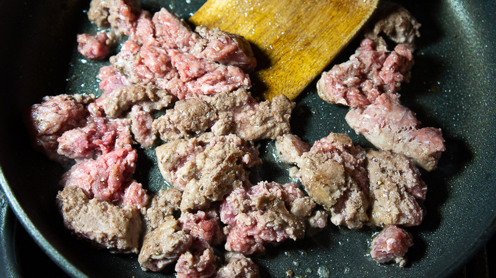 a pan of browning ground beef