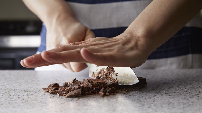 person chopping chocolate