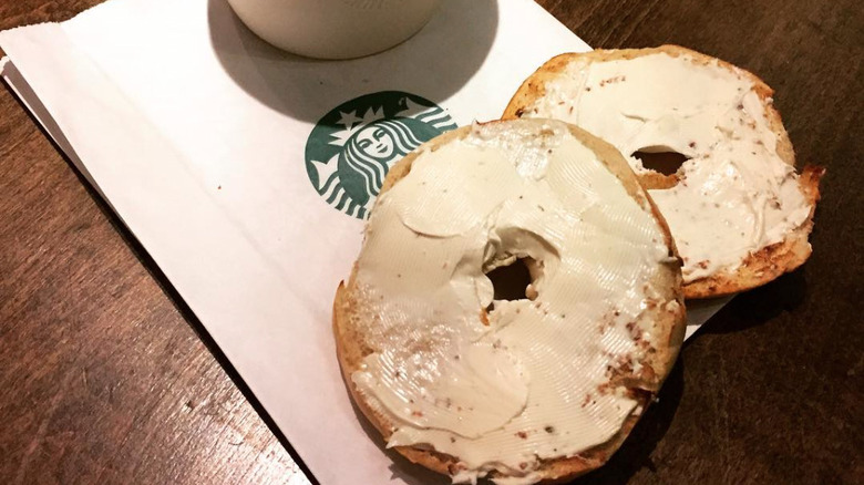 Bagel with cream cheese and Starbucks logo