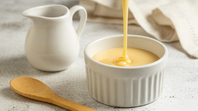 Condensed milk pouring into ramekin