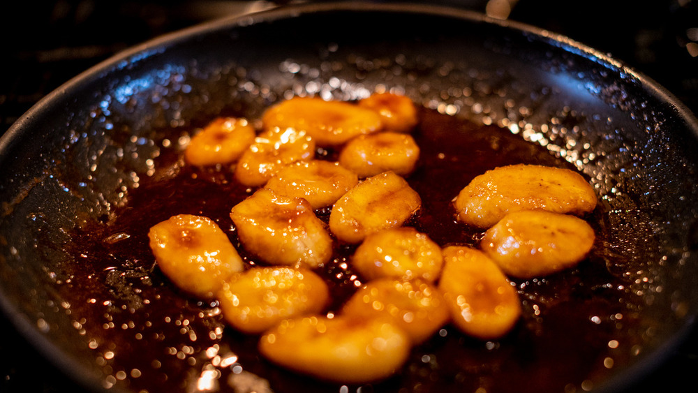 Banana slices cooking in sauce