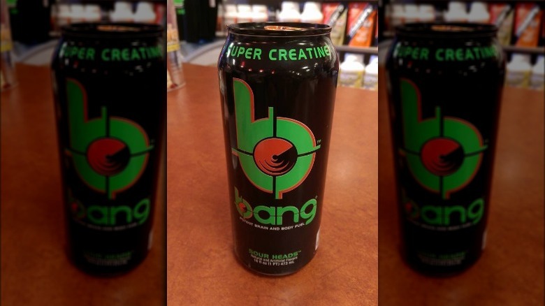 Three cans of Bang Energy Sour Heads drink on store counter