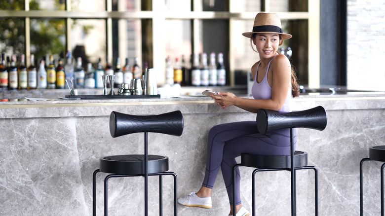 lady alone at bar