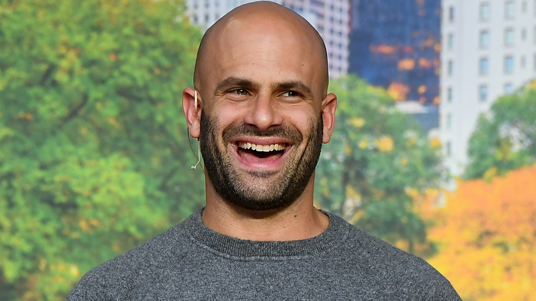 Sam Kass smiling in cooking demonstration