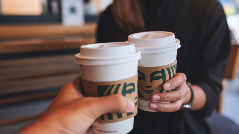 Friends holding Starbucks drinks