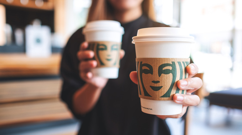 Barista handling Starbucks cups