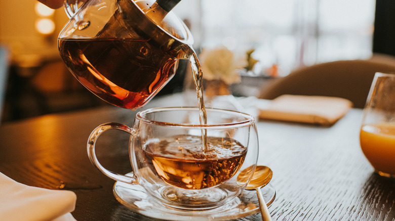 Person pouring hot tea