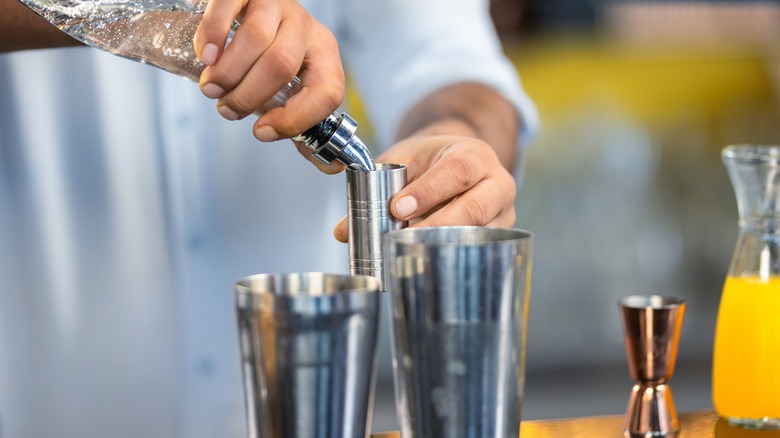 Bartender measuring alcohol