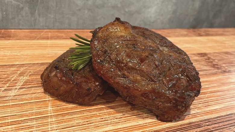 cooked chuck eye steaks on a cutting board