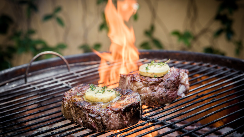 grilling steaks with open flame