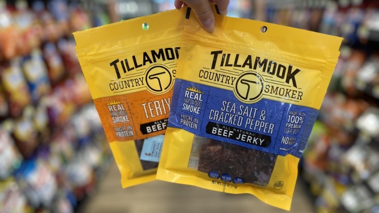 Person holding Tillamook Beef Jerky in store