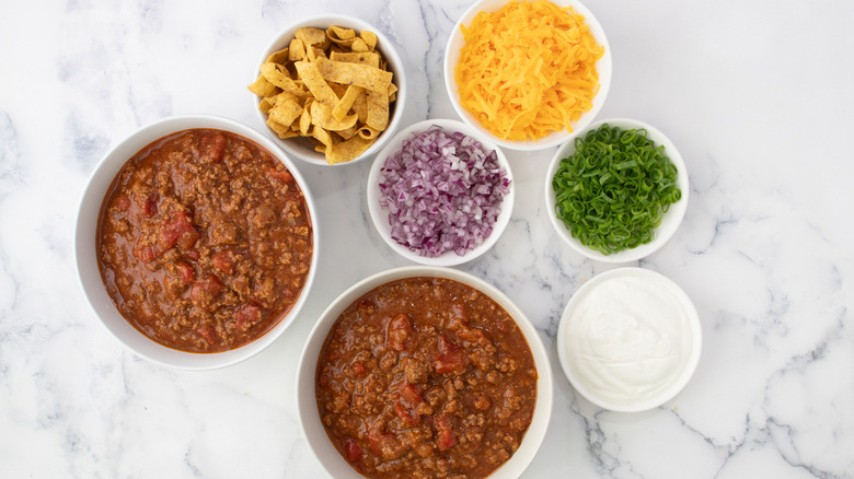 bowls of chili and toppings