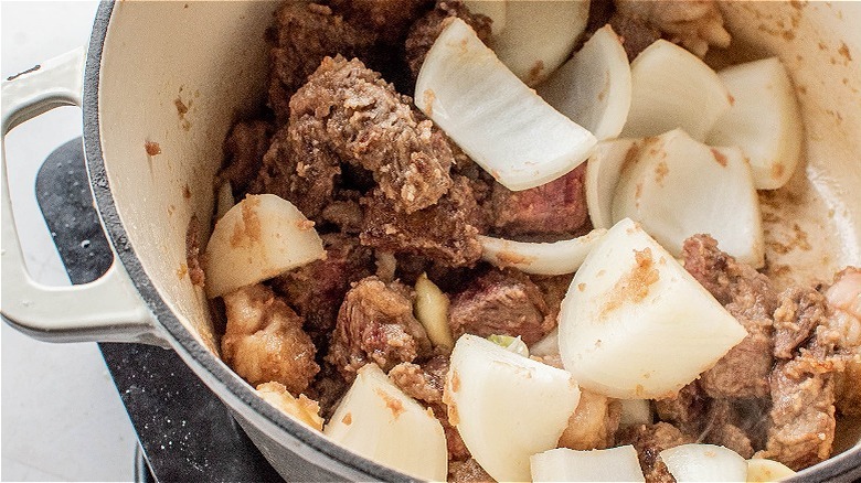 beef and onions cooking in pot