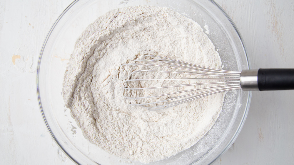 dry ingredients for bread baking in a bowl with whisk