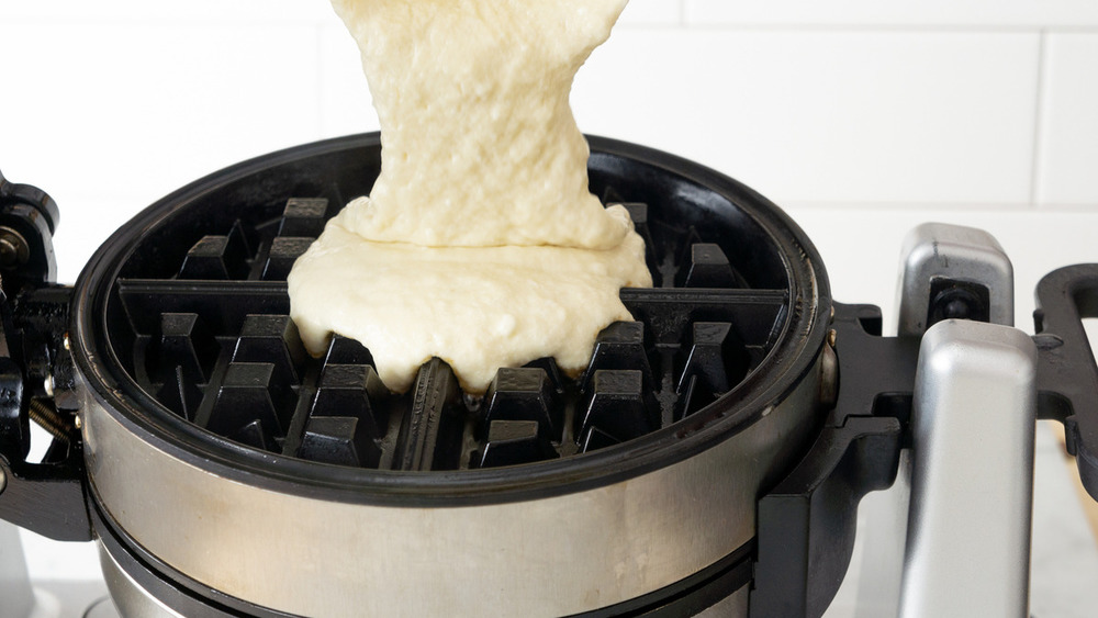 pouring belgian waffle batter