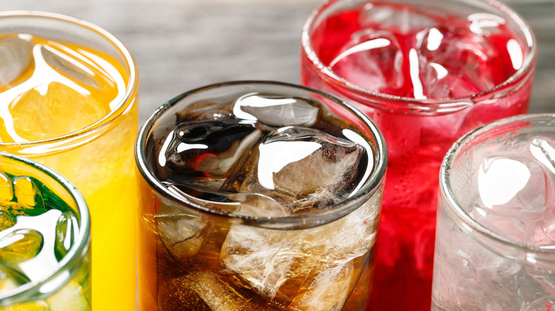 line of sodas in clear glasses