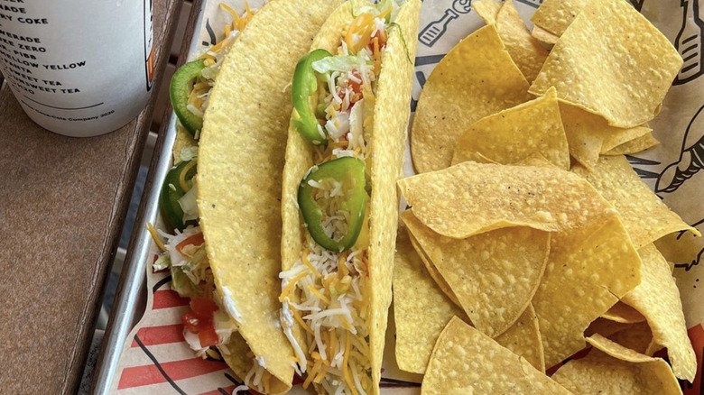 Hard taco and tortilla chips on tray