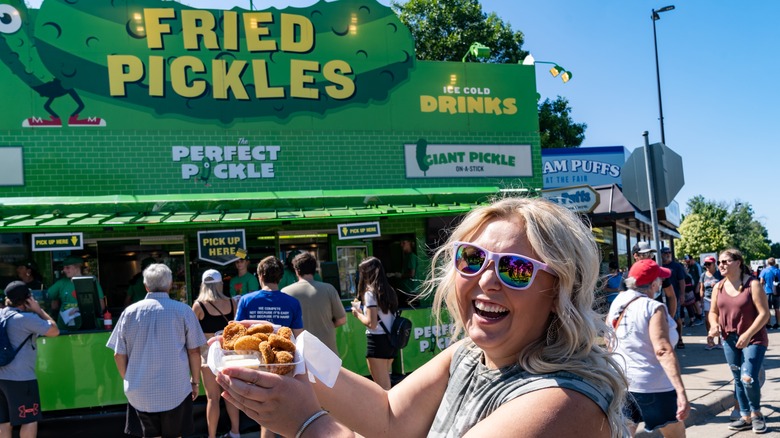 Woman holding fried pickles