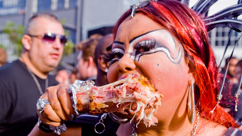 Festival woman eating turkey leg