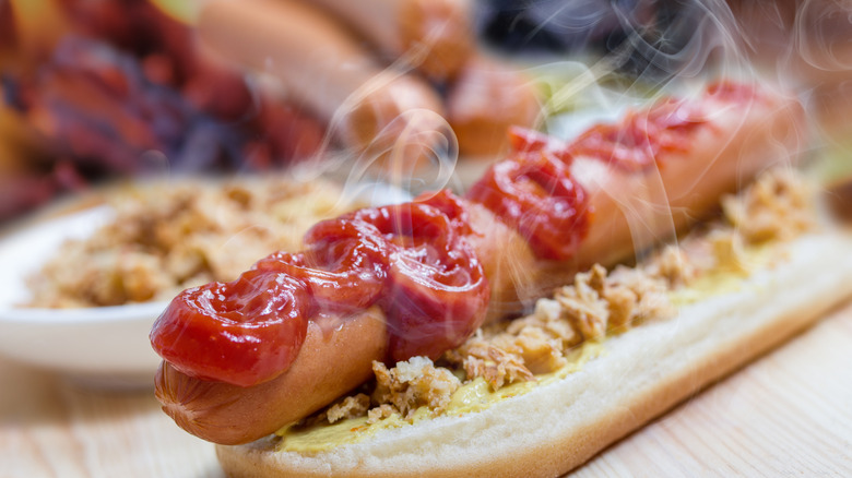 steaming hot dog with ketchup