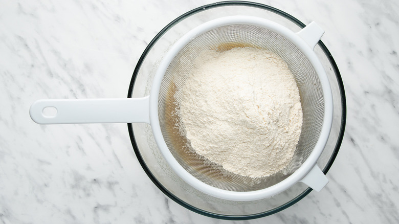 sifting flour into wet ingredients