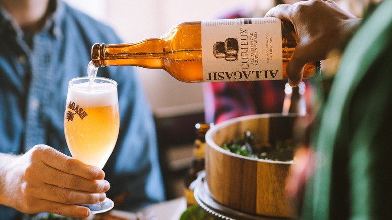 Pouring Allagash beer into a glass