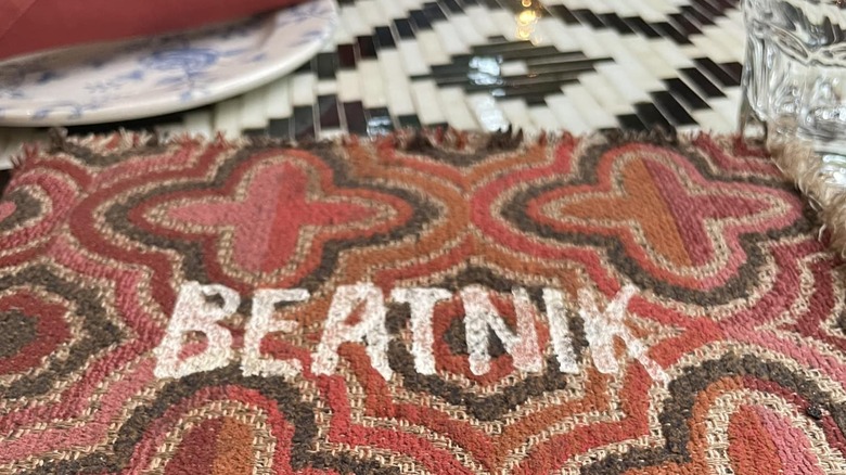 Beatnik table cloth on black and white tile table