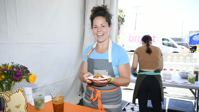 Chef Stephanie Izard holding a plate of food