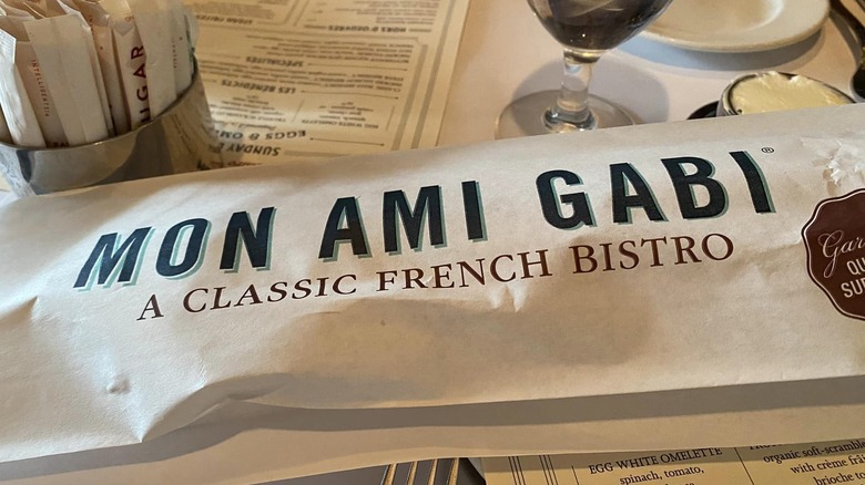 Bread in a Mon Ami Gabi logo paper bag