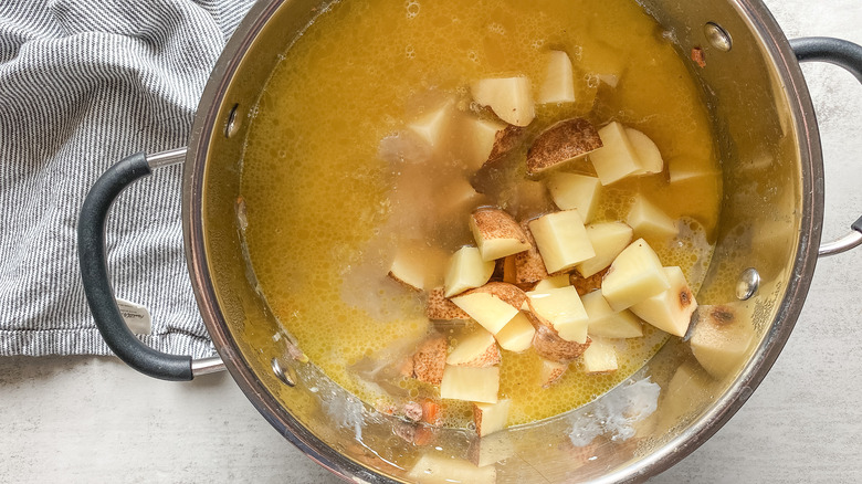 broth and potatoes in pot