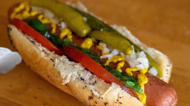 Chicago Dog in poppyseed bun topped with relish, pickles, tomatoes and mustard