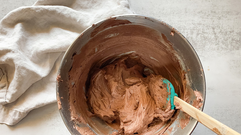 Frosting with spatula in mixer