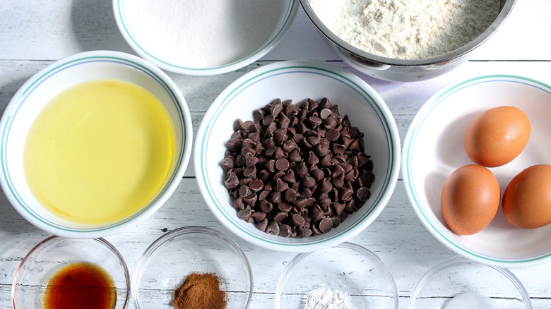 Bowls with dry and wet ingredients for chocolate chip cookies