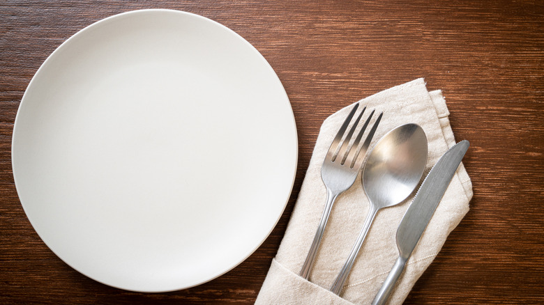 Flatware and plate on wood