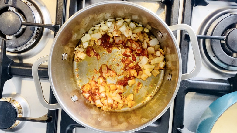 onions in saucepan with tomato paste