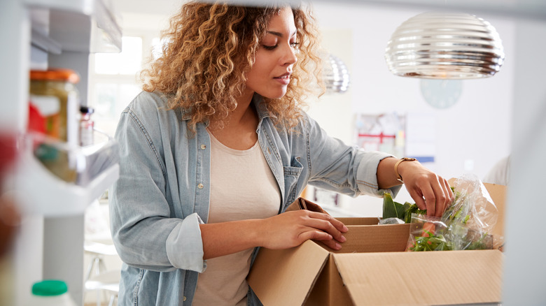 Woman unboxing meal kit 