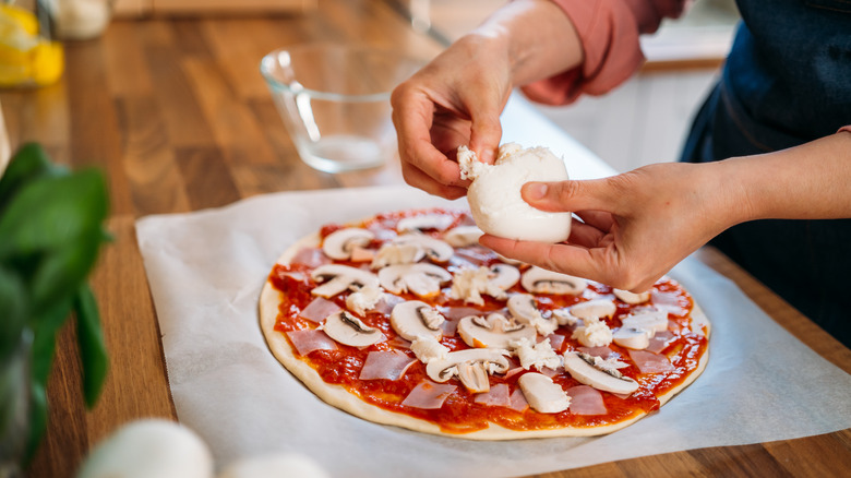 Person making pizza