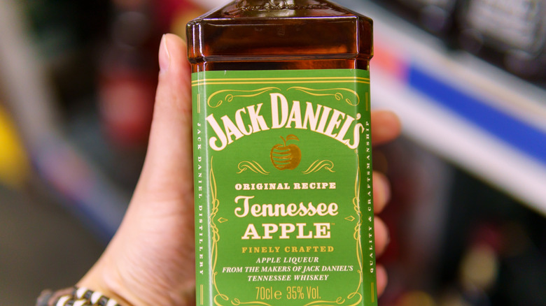 Hand holding Jack Daniel's Tennessee Apple 