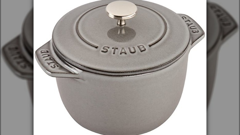 A grey Staub pot on a white background