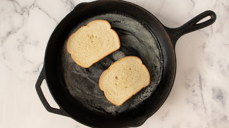 toasting bread slices in skillet