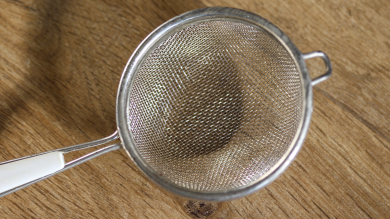 Fine wire sieve on wooden counter