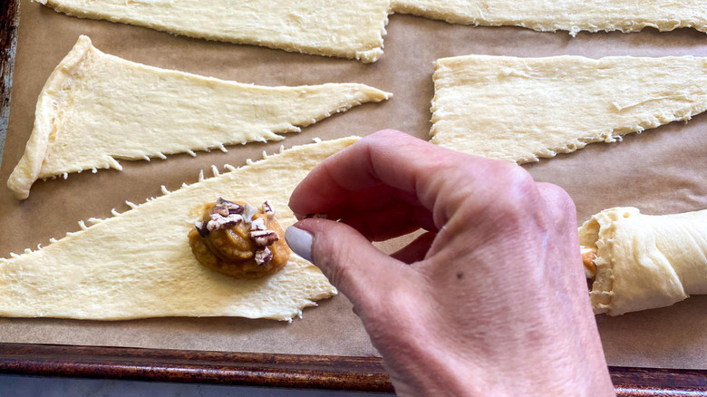 hand sprinkling pecans 