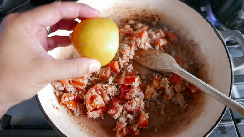 adding lemon juice to skillet