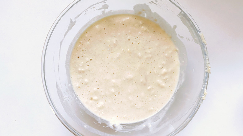 clear glass bowl of lumpy, bubbly pancake batter