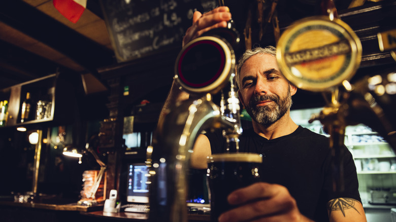 Bartender pouring draft beer