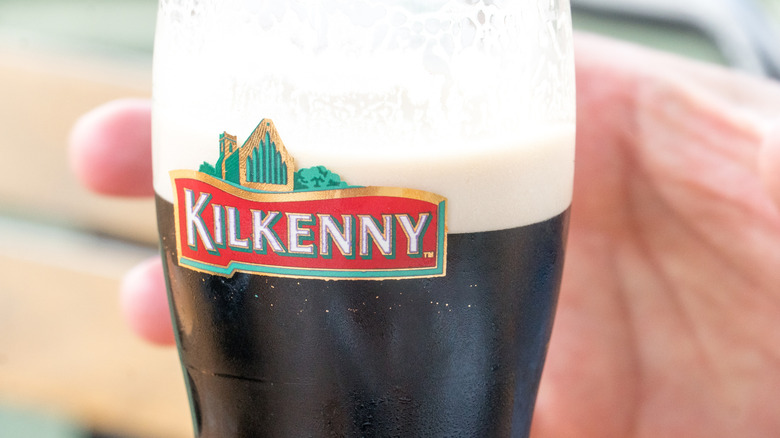 Hand holding a Kilkenny pint